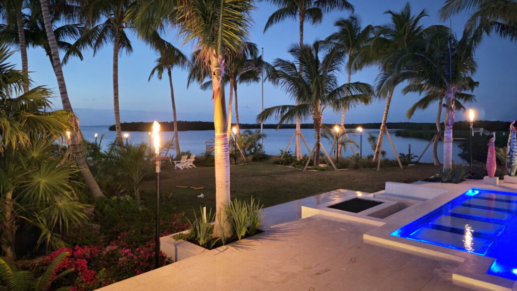 gas torches in a waterfront backyard